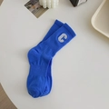 Klein blue cotton crew socks with white embroidered letter C in a stylish lifestyle setup - Blue