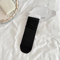 Slouchy black crew socks with white lace trim and ribbed knit texture for women - Black