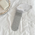 Grey knit mid-calf socks with white lace trim and ribbed texture in soft packaging - One Size / Dark Gray