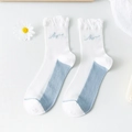 White crew socks with blue contrast toe and heel, featuring cute ruffle trim and embroidery - Blue White Patchwork Letters