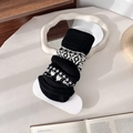 Vintage-Beinstulpen in Schwarz-Weiß gestrickt mit modischem Hahnentrittmuster für Damen - Schwarz