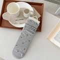 Gray knitted crew socks with black polka dots and white hook tag on wooden tray - One Size / Dark Gray