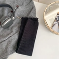 Dicke schwarze gerippte Strickstulpen in einem modischen Lifestyle-Layout präsentiert - Einheitsgröße / Schwarz