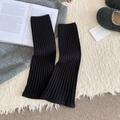 Chic black ribbed knit leg warmers in a cozy home setting for fall and winter seasons - Black