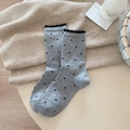 Gray wool socks with black heart patterns and ruffled edges in a warm home setting - Light Gray