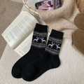 Thick black wool crew socks featuring white reindeer patterns for winter warmth - One Size / Black