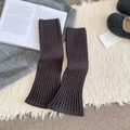 Dark charcoal grey ribbed knit leg warmers for women in a cozy winter home setting - Dark Gray