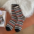 Thick wool socks with colorful stripes and woven label on a rustic wooden background - One Size / Coffee