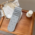 Grey knit slouch socks with purple floral embroidery in a cozy lifestyle setting - Light Gray