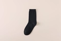 Classic black mid-calf cotton business socks featuring a ribbed cuff and smooth knit texture - One Size / Black