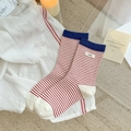 Cozy red and white striped crew socks with a navy cuff and stylish egg fabric label - Red