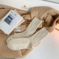 Oatmeal ribbed knit mid-calf thermal socks shown on soft fabric in a cozy setting - One Size / Khaki