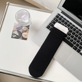 Vertical ribbed black cotton crew socks displayed on a laptop in a lifestyle setting - Black
