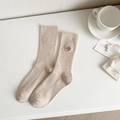 Beige crew socks with vertical rib knit and pink cartoon embroidery on white background - Oatmeal