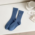 Sky blue rib-knit crew socks featuring a minimalist smiley face embroidery detail - Navy Blue