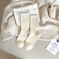 Cozy cream-colored ribbed cotton crew socks for women on a decorative warm knit background - One Size / Oatmeal