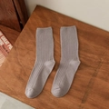 Greyish purple cotton crew socks with vertical stripes shown on a vintage wooden table - Gray