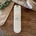 Cream knit crew socks featuring vintage cable patterns on a rustic wooden surface - Milk White Cable Knit