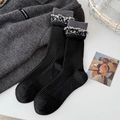 Women's black wool knit mid-calf socks with floral lace trim and ribbed texture - Black