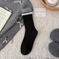Black speckled wool socks with white plush trim and grey ribbed cuffs for winter warmth - Black