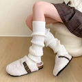 Detail of white cable knit leg warmers paired with fuzzy sherpa cork buckle slippers - One Size / White