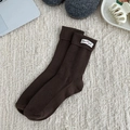Dark brown ribbed cotton slouch socks featuring a decorative white fabric label - One Size / Dark Brown