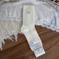 Creamy white mid-calf socks with vertical ribs and golden metal bow decoration - One Size / White