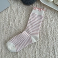 Pink striped wool socks for women with ruffle trim design on a plush cream background - One Size / Striped