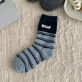 Navy blue and light blue striped wool socks with white logo patch in a cozy home setting - One Size / Light Blue Striped