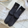 Charcoal grey knit wool socks with white letter embroidery on a plush background - One Size / Dark Gray