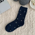 Navy blue crew socks with pink floral jacquard pattern on a soft knitted carpet - One Size / Floral
