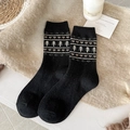 Black wool socks with Fair Isle heart pattern on beige faux fur background - One Size / Black