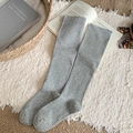 Classic grey ribbed knit thigh high socks displayed on a rustic woven basket - One Size / Light Gray