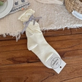 Creamy ballet-style calf socks with grey silk ribbon bow and ruffled edges for women - White