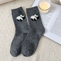 Dark grey wool socks with cute panda pattern laid on a cozy knit rug background - One Size / Dark Gray