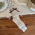 Beige ballet style slouch socks with brown ribbons on textured knit fabric - Khaki