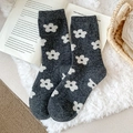 Dark grey wool socks with white floral pattern on a cozy carpet setting - One Size / Dark Gray