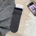 Dark grey ribbed mid-calf socks with navy rolled edge shown on a cozy wool background - One Size / Dark Gray