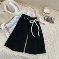 Black knit leg warmers with white bows and flared cuffs for a cozy winter outfit - One Size / Black