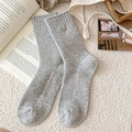 Mid-calf grey ribbed wool socks with metal button accent in cozy lifestyle setting - One Size / Light Gray