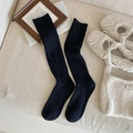 Classic black cable knit knee-high socks featuring vertical ribbed patterns and warm cotton texture - One Size / Black