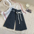 Dark gray knitted leg warmers with white drawstring bows in a cozy winter setting - One Size / Dark Gray