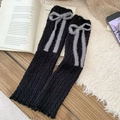 Scaldamuscoli in maglia nera con fiocco in peluche grigio e bordo a ruches - Taglia unica / Nero