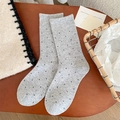 Cute light grey wool socks with black polka dots shown on a rustic wooden background - One Size / Light Gray