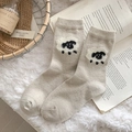 Chaussettes en laine beige avec motif mouton 3D dans un décor chaleureux - Taille unique / Blanc Cassé