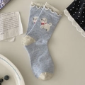 Light blue crew socks with cute bichon puppy pattern and white lace ruffle trim - One Size / Blue