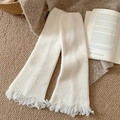 White ribbed knit leg warmers with fringe details in a stylish autumn winter setting - One Size / White
