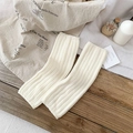 Cozy cream white ribbed knit leg warmers in a soft minimalist winter style setup - One Size / White