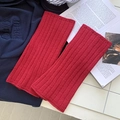 Vibrant red ribbed knit leg warmers with soft textured fabric for a winter cozy style - Red