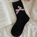 Black knitted mid-calf socks featuring a pink plush bow with a white flower button - Black
